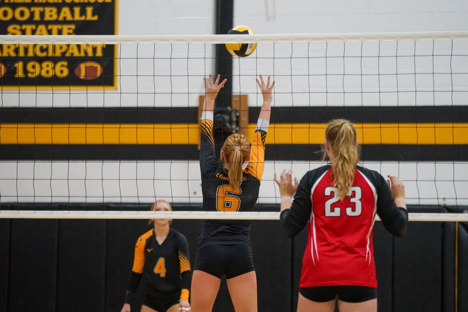 Lone Tree’s Ella Buser sets the ball during Thursday’s win over Pekin.